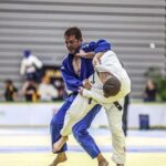 Wayne Phipps, Australian Judoka grappling with opponent on the mat.