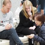 Brendan and Rachel experience a presentation and demonstration by Ashirase, Inc. regarding their navigation device for the visually impaired.