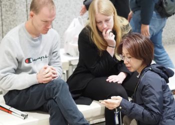 Brendan and Rachel experience a presentation and demonstration by Ashirase, Inc. regarding their navigation device for the visually impaired.