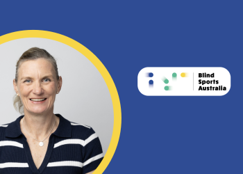 Felicity Wilkeson smiling in a portrait, wearing a navy-and-white striped collared shirt. She is framed within a yellow circle on a teal and dark-blue graphic background, with the Blind Sports Australia logo in the upper-right corner.