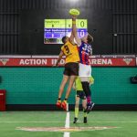 Two Blind AFL players in the air competing at a centre bounce
